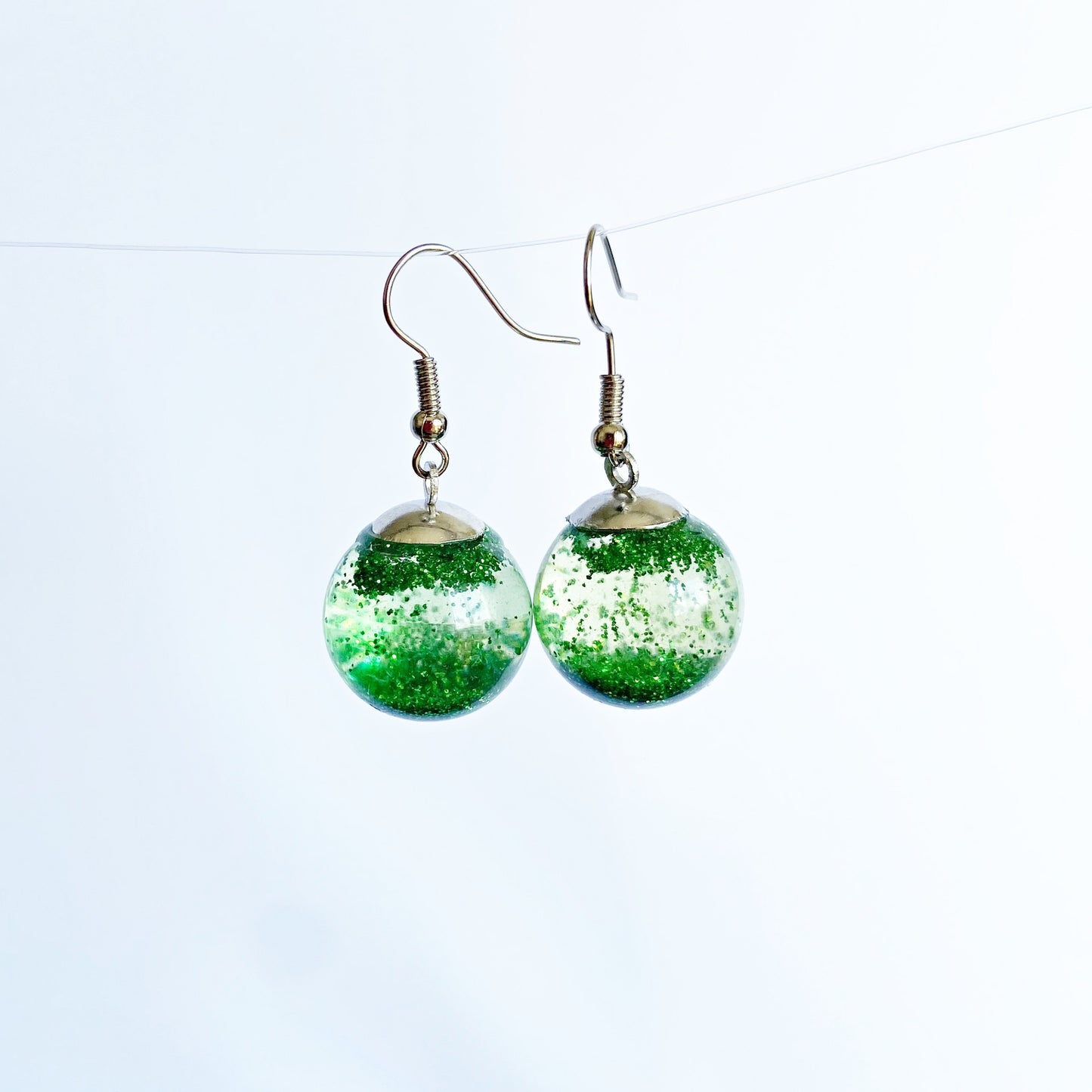 Green sequins floating in a glass bottle earrings Snow globe jewelry Glass globe flying snowflakes winter jewelry Christmas gift for women