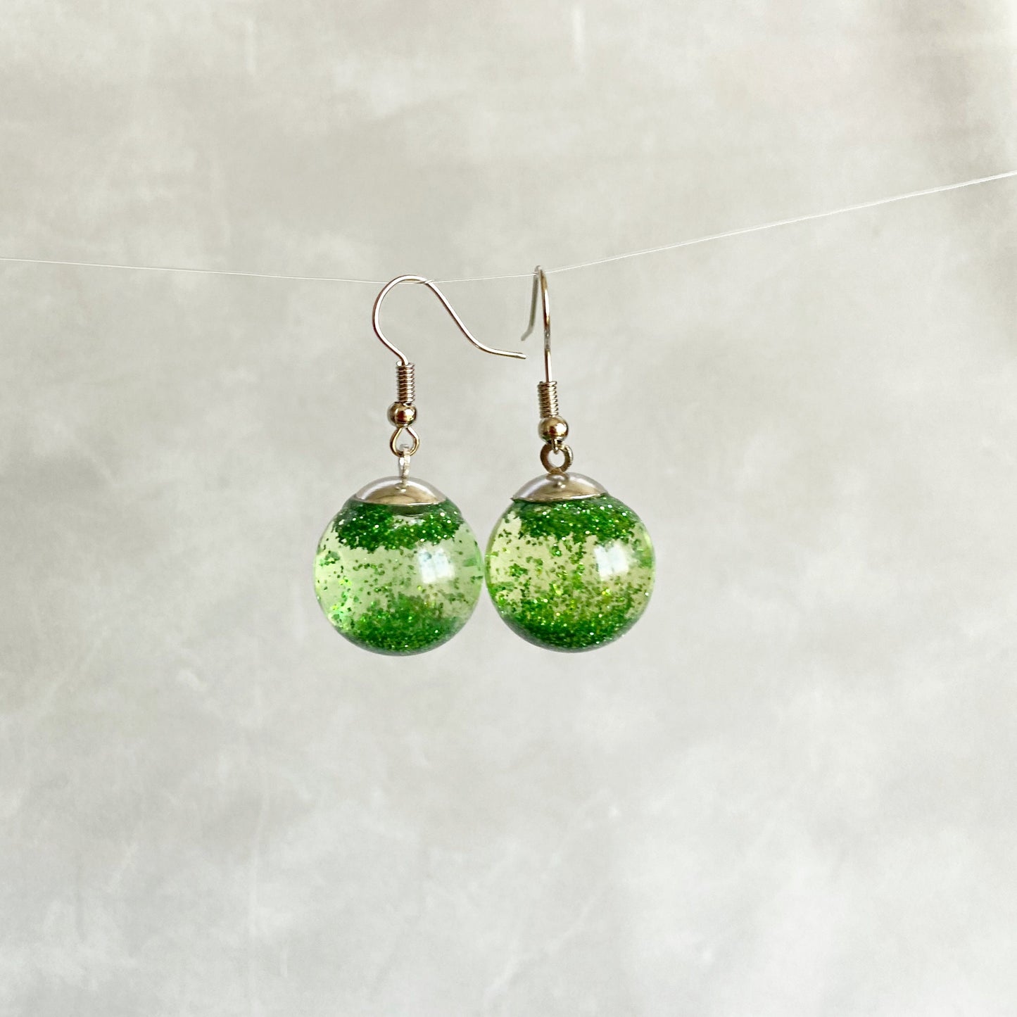 Green sequins floating in a glass bottle earrings Snow globe jewelry Glass globe flying snowflakes winter jewelry Christmas gift for women