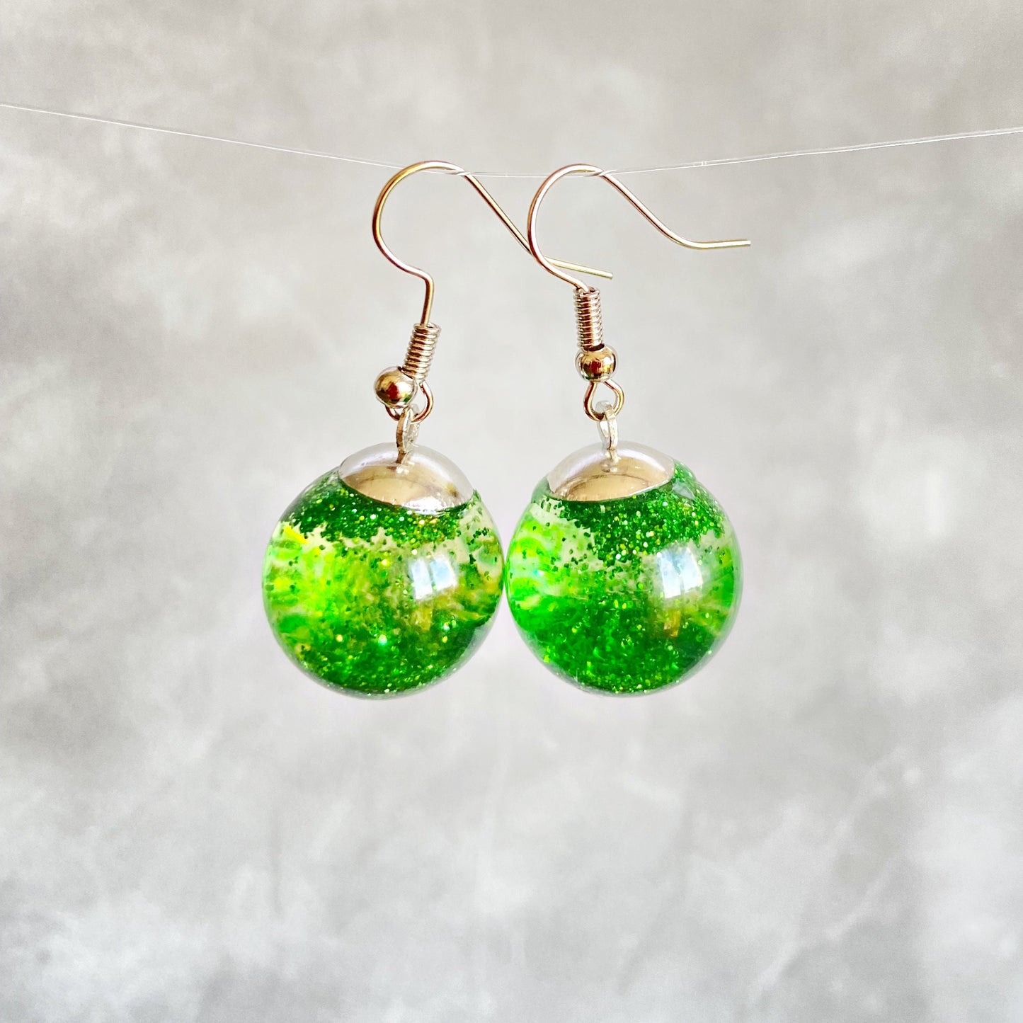 Green sequins floating in a glass bottle earrings Snow globe jewelry Glass globe flying snowflakes winter jewelry Christmas gift for women